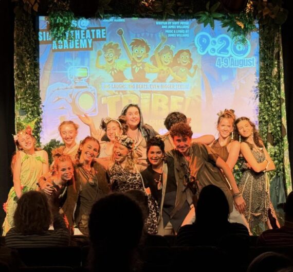 A group of young people behind a projection.