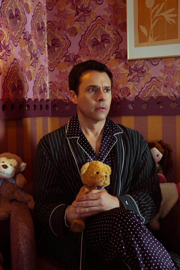 Brian Saffi, looking concerned and holding a teddy bear